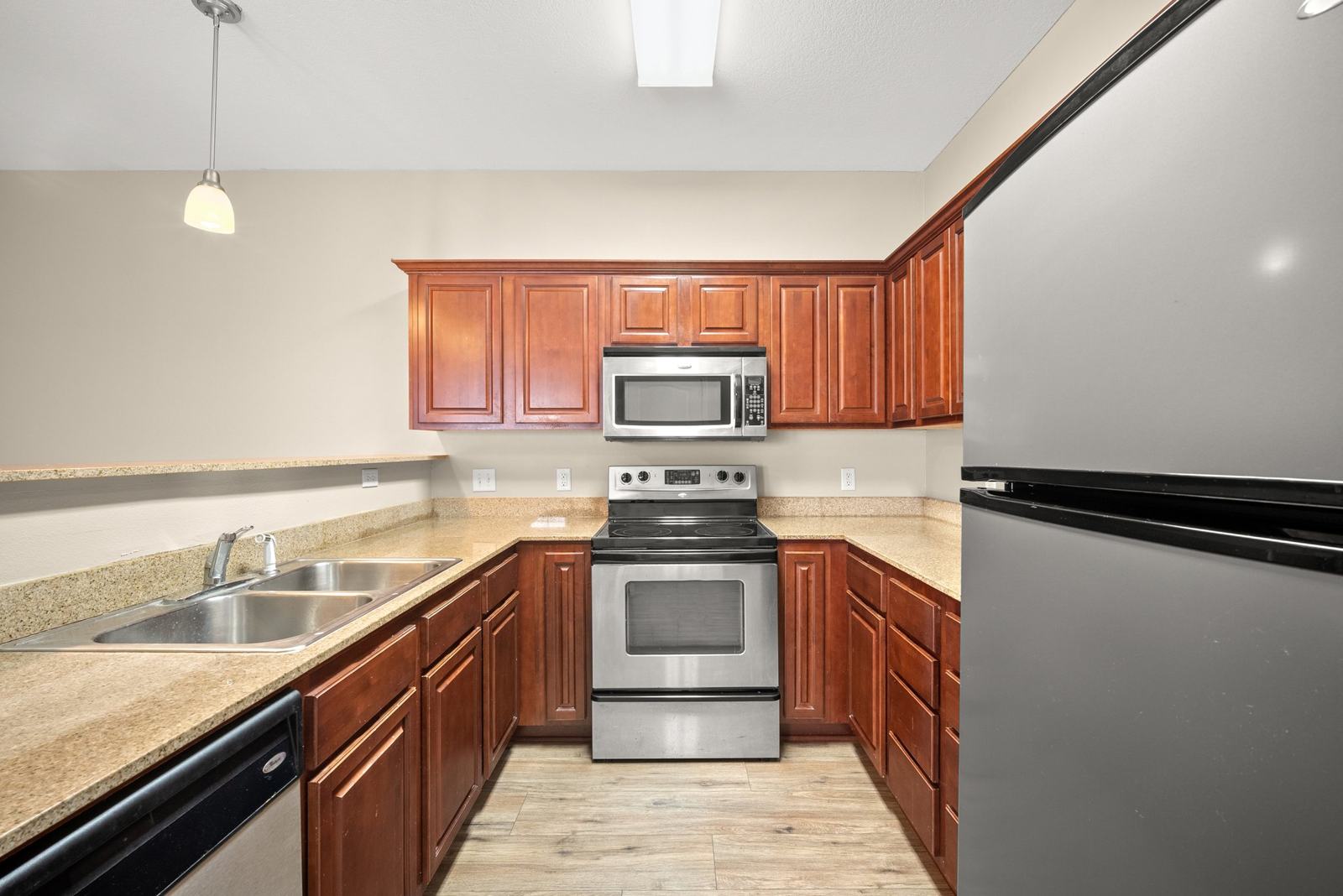 Kitchen with granite countertops, cherry cabinets and stainless steel appliances